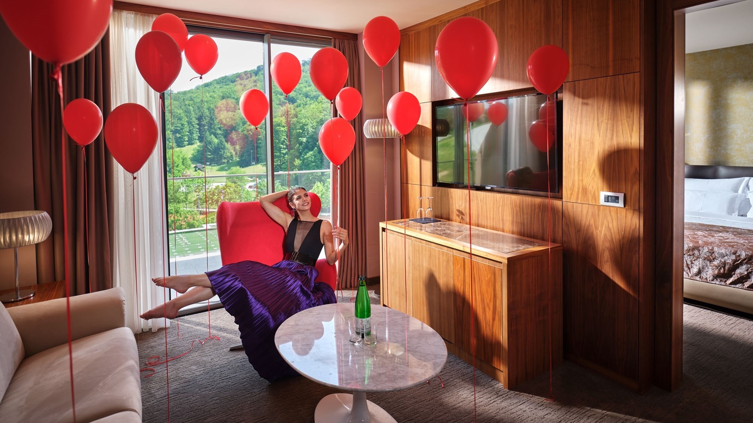 woman in room with red balloons